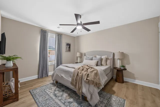 a bedroom with a bed and a potted plant