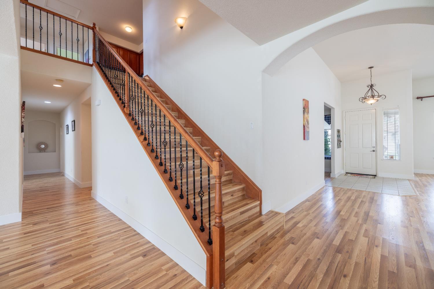 10050 Cameron Pines Way Sacramento, CA 95829 - Photo 18 of 31 a view of a hallway with wooden floor and staircase