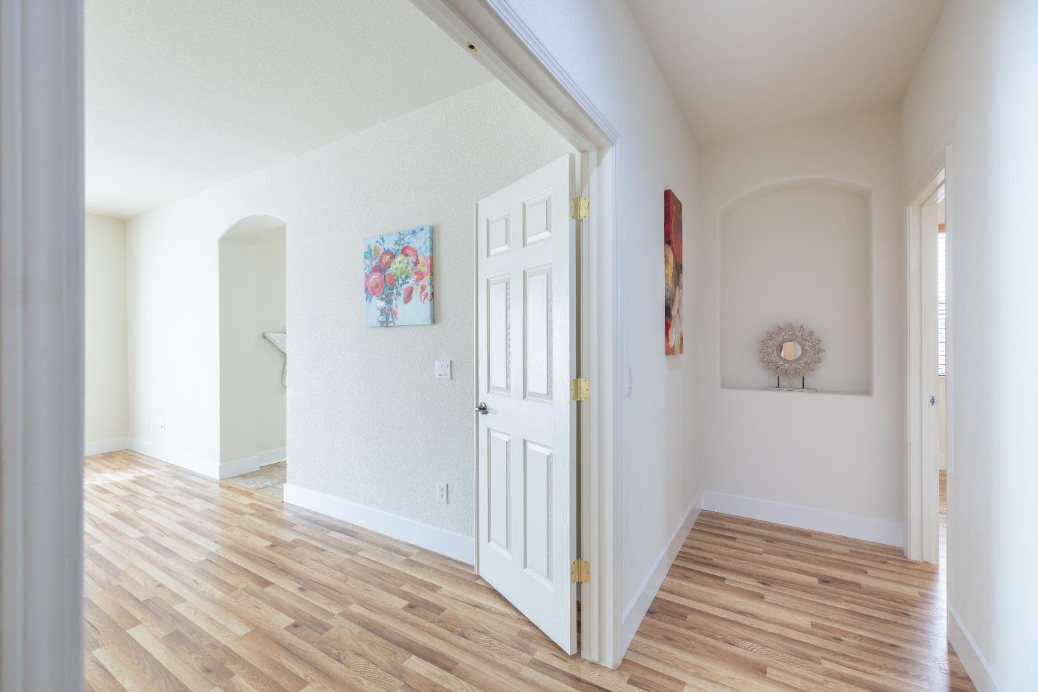 10050 Cameron Pines Way Sacramento, CA 95829 - Photo 22 of 31 a view of a hallway with wooden floor and closet