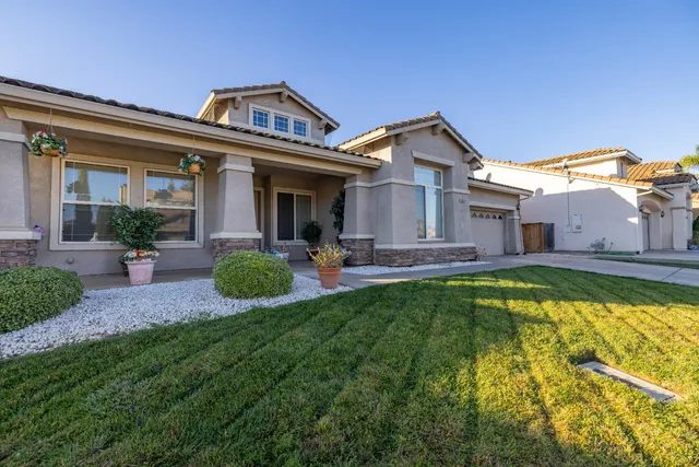 a view of a house with a yard patio and swimming pool
