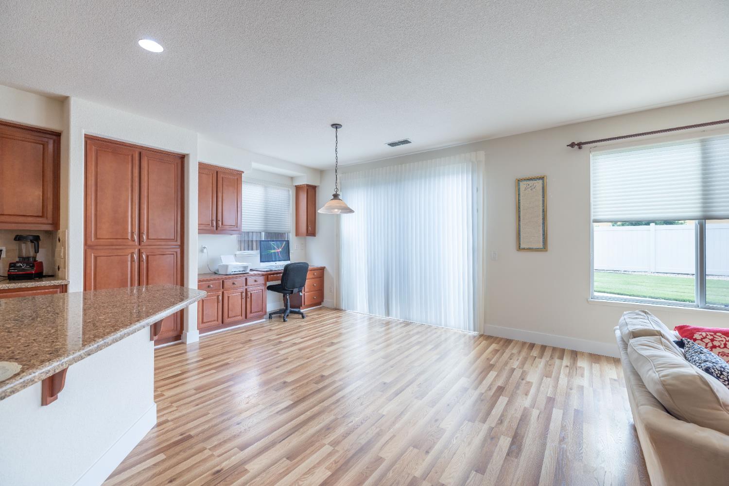 10050 Cameron Pines Way Sacramento, CA 95829 - Photo 6 of 31 a view of a kitchen with kitchen island wooden floors center island and stainless steel appliances