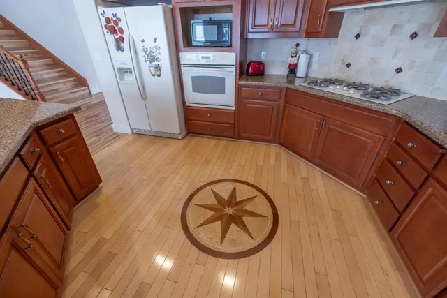 a kitchen with wooden cabinets and a stove