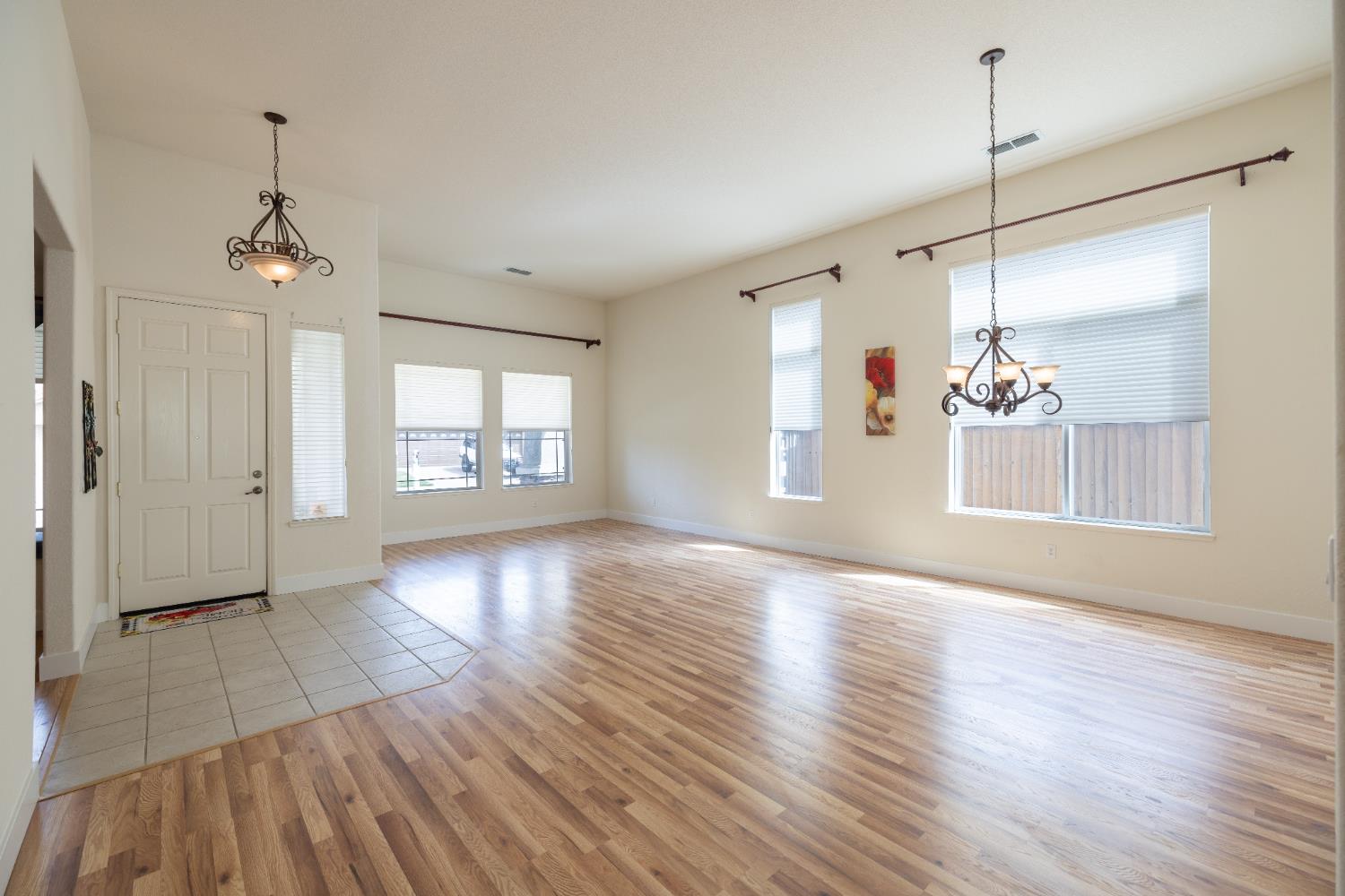 10050 Cameron Pines Way Sacramento, CA 95829 - Photo 10 of 31 a view of a room with wooden floor chandelier and windows