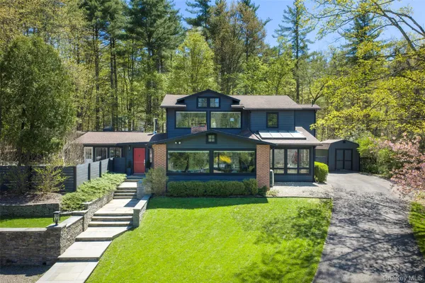 a front view of a house with yard and green space