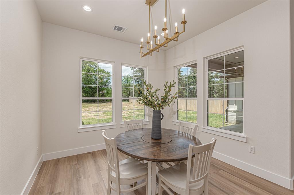 360 Dalton Road Canton, TX 75103 - Photo 12 of 33 Dining space featuring a linear chandelier with a gold-tone finish, recessed lighting, and wood-finish flooring