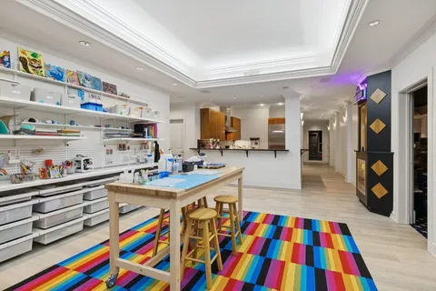 a room with lots of white furniture and baby crib