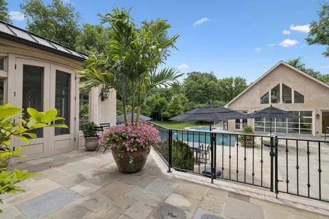 a view of a patio with a table and chairs under an umbrella