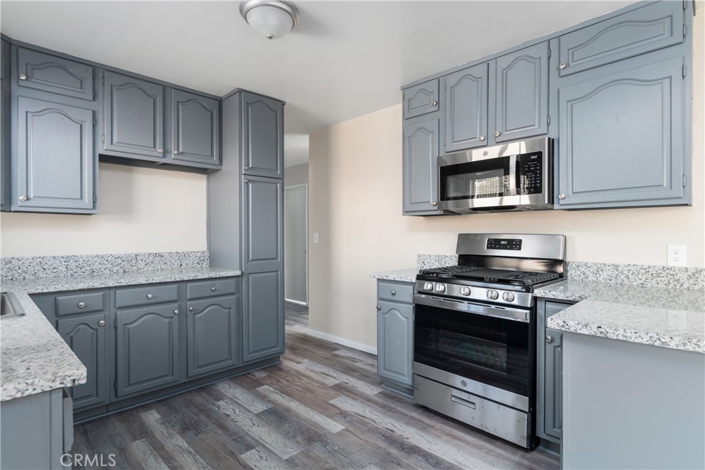 9395 53rd Street Riverside, CA 92509 - Photo 1 of 1 a kitchen with granite countertop cabinets stainless steel appliances and a sink