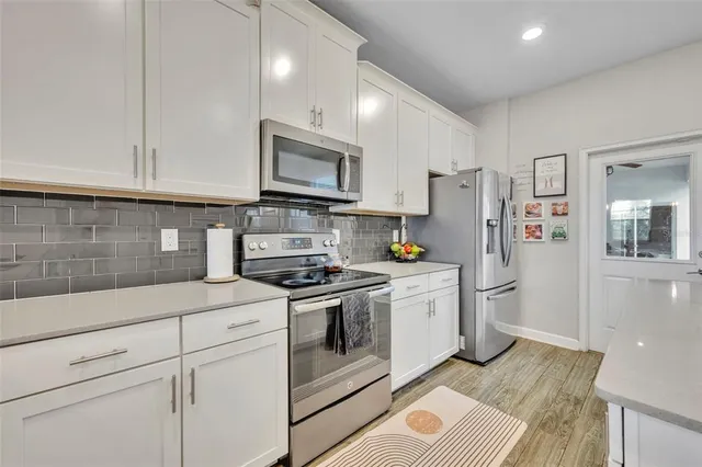 a kitchen with stainless steel appliances granite countertop a refrigerator sink and stove