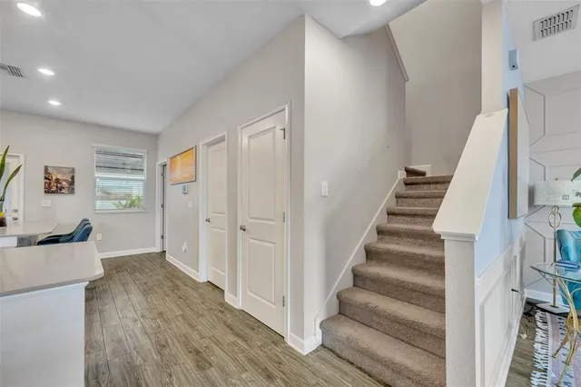a view of a hallway with wooden floor and entryway