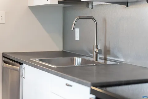 a kitchen with a sink and a refrigerator