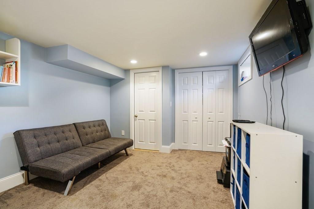 26 Rinaldo Road Weymouth, MA 02191 - Photo 23 of 27 a living room with furniture and a flat screen tv