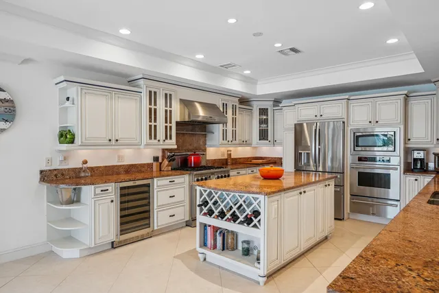 a living room with lots of furniture and view of kitchen