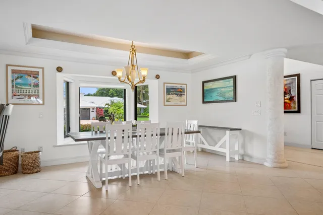 a living room with furniture a flat screen tv and a large window