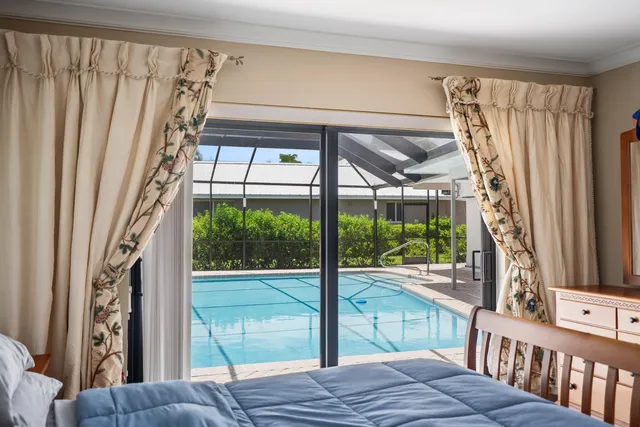 a view of a swimming pool with chairs in patio