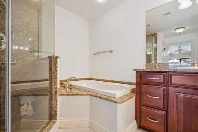 a view of a patio with a table and chairs under an umbrella
