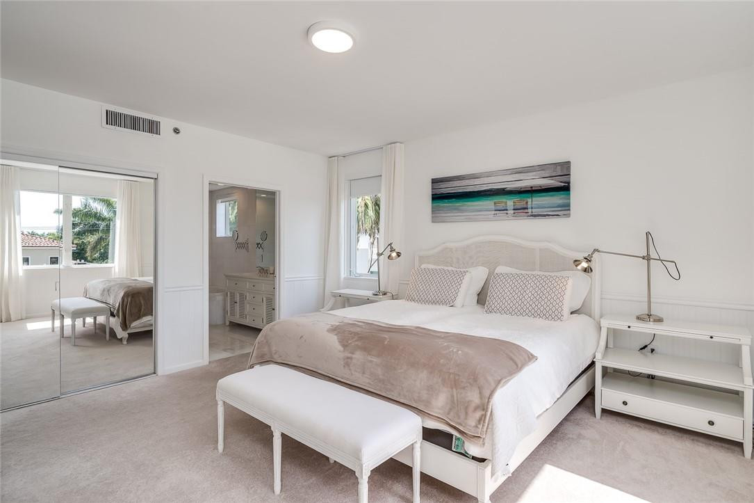 217 Hendricks Isle, Unit 402 Fort Lauderdale, FL 33301 - Photo 11 of 39 a bedroom with a bed and a couch