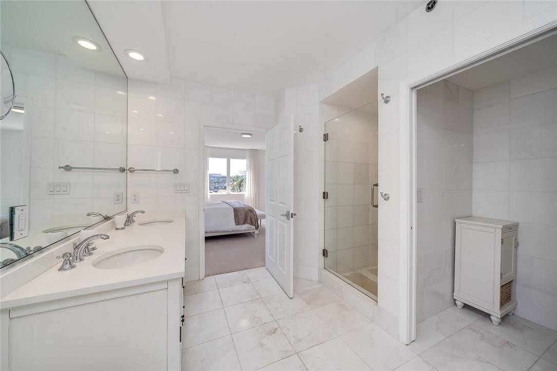217 Hendricks Isle, Unit 402 Fort Lauderdale, FL 33301 - Photo 13 of 39 a bathroom with a sink a toilet and shower
