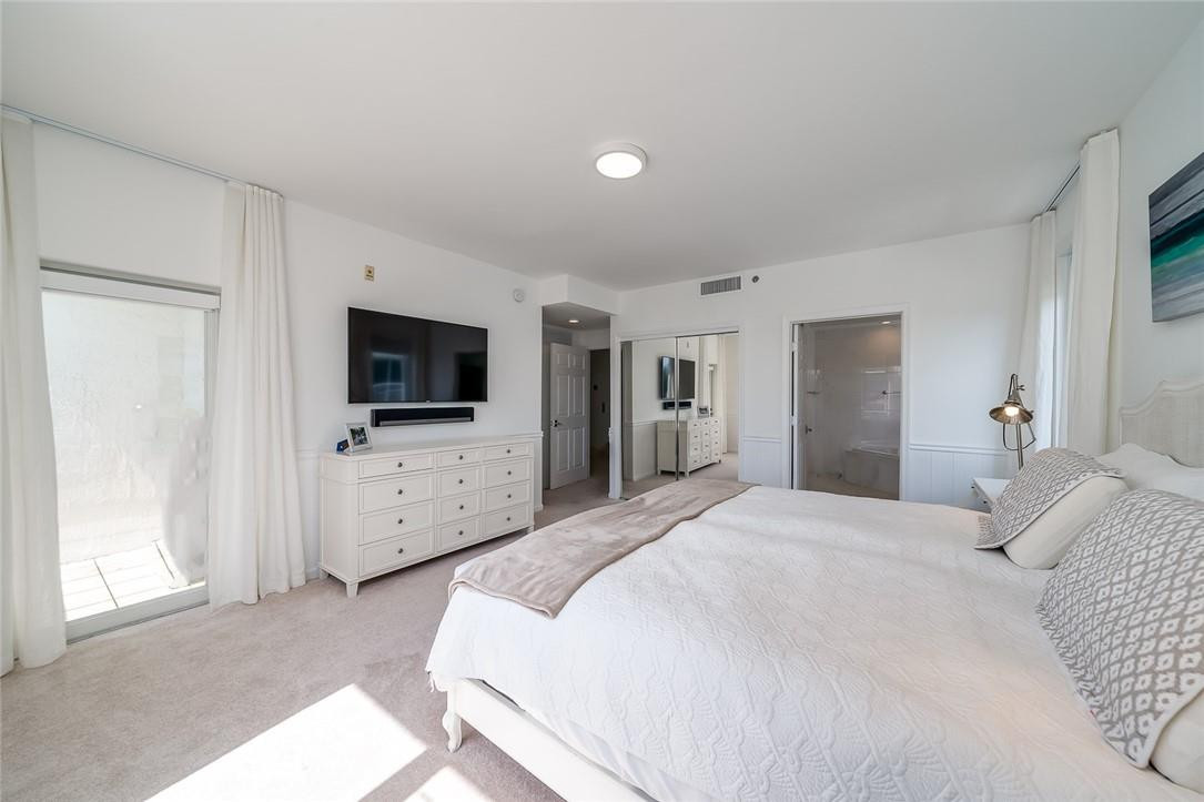 217 Hendricks Isle, Unit 402 Fort Lauderdale, FL 33301 - Photo 15 of 39 a bedroom with flat screen tv and a bed