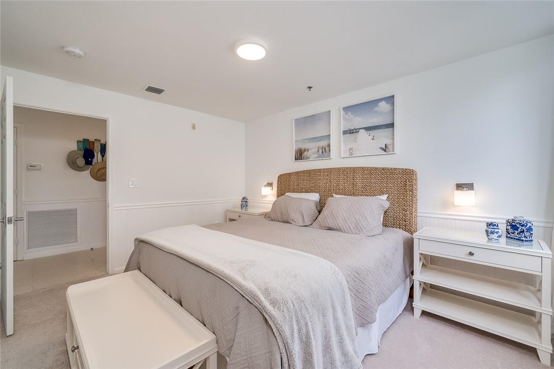 217 Hendricks Isle, Unit 402 Fort Lauderdale, FL 33301 - Photo 18 of 39 a bedroom with a bed and a lamp