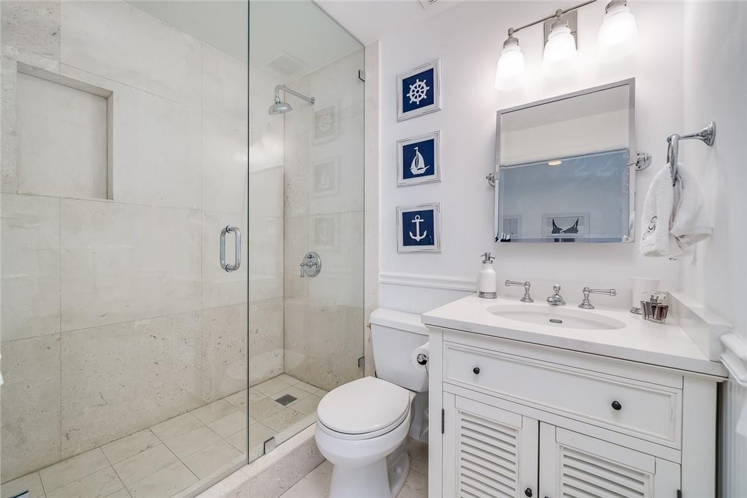 217 Hendricks Isle, Unit 402 Fort Lauderdale, FL 33301 - Photo 19 of 39 a bathroom with a sink toilet and shower