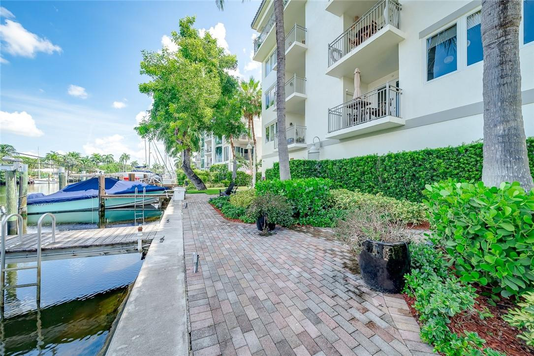 217 Hendricks Isle, Unit 402 Fort Lauderdale, FL 33301 - Photo 24 of 39 a pathway of a house with a yard and potted plants