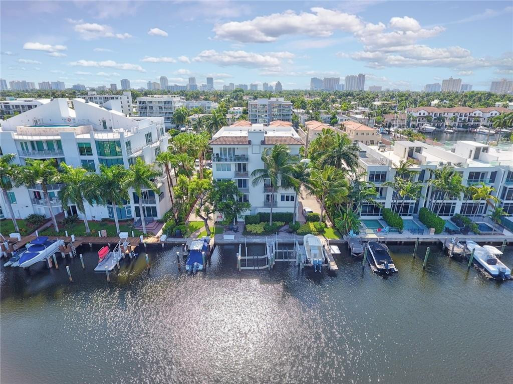 217 Hendricks Isle, Unit 402 Fort Lauderdale, FL 33301 - Photo 28 of 39 an aerial view of a house with a garden and lake view