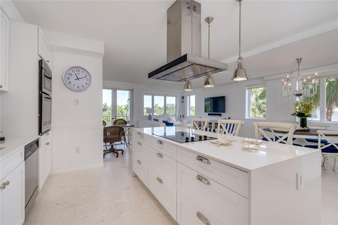217 Hendricks Isle, Unit 402 Fort Lauderdale, FL 33301 - Photo 3 of 39 a large white kitchen with a large window and couch