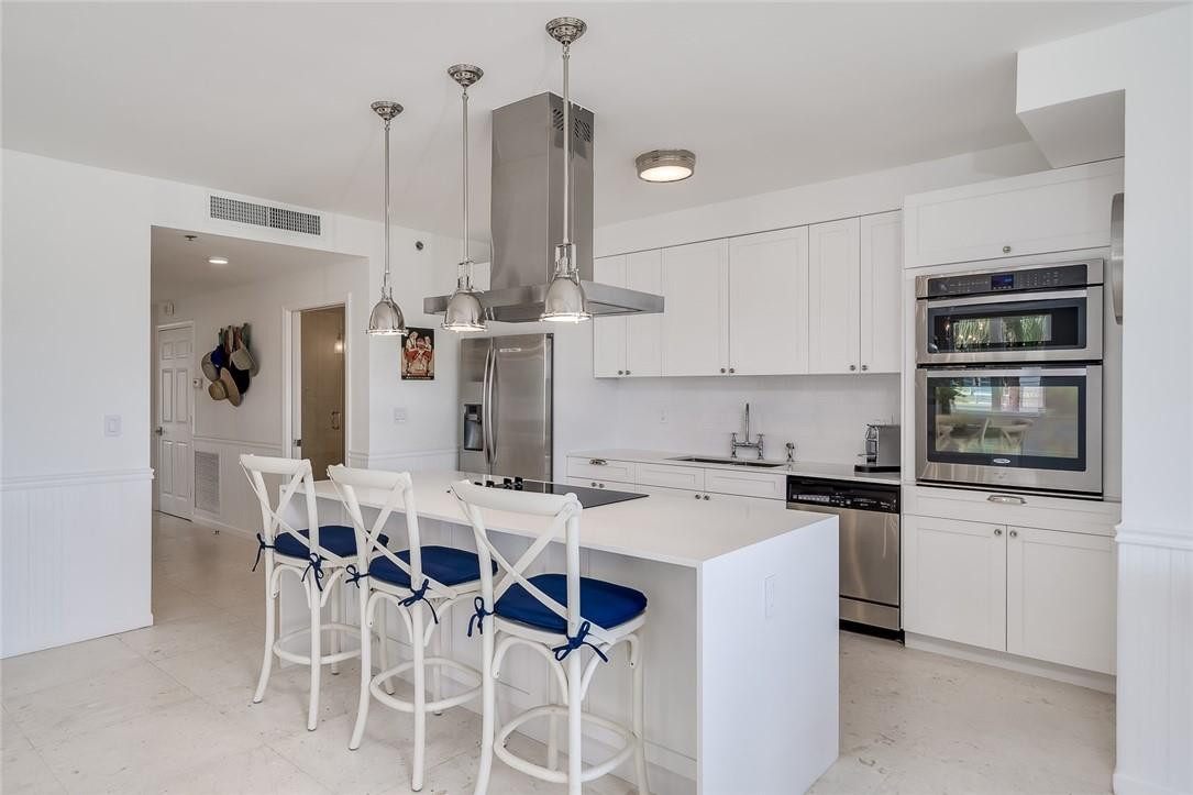 217 Hendricks Isle, Unit 402 Fort Lauderdale, FL 33301 - Photo 4 of 39 a kitchen with appliances a sink and cabinets