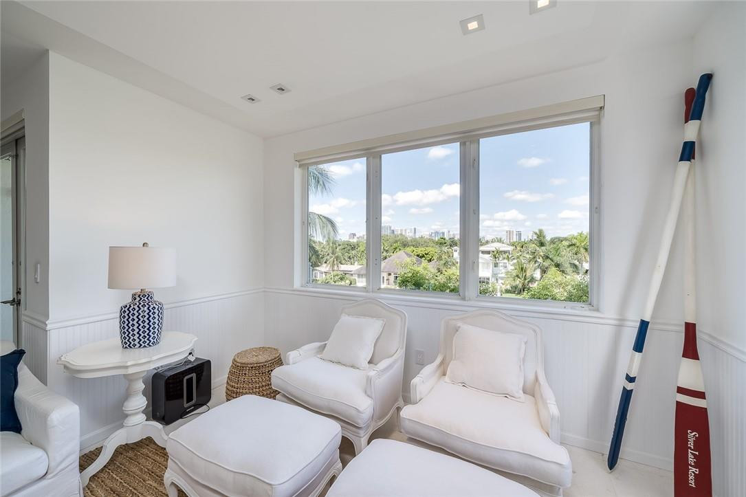 217 Hendricks Isle, Unit 402 Fort Lauderdale, FL 33301 - Photo 8 of 39 a living room with furniture and a large window