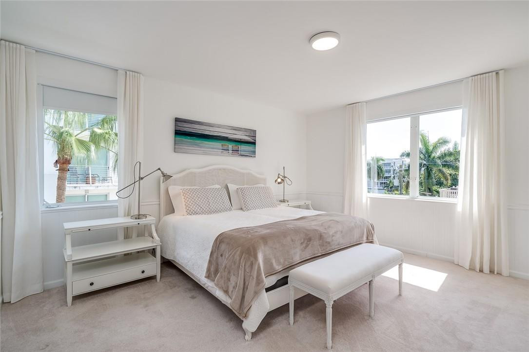 217 Hendricks Isle, Unit 402 Fort Lauderdale, FL 33301 - Photo 10 of 39 a bedroom with a bed and a window