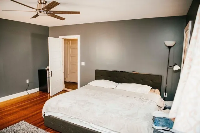 a view of a house with a barbeque and wooden stairs