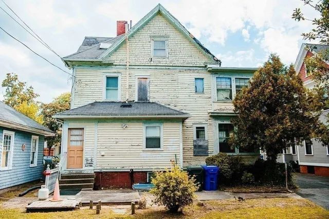 a view of a building with a large tree