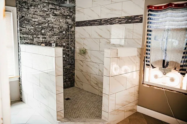 a kitchen with cabinets appliances a sink and a window