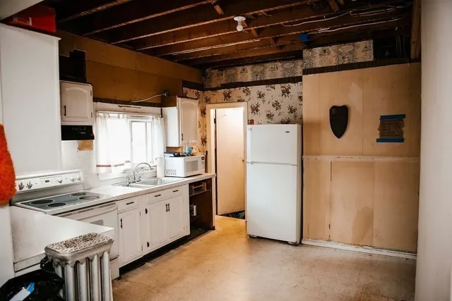 a kitchen with cabinets a sink and appliances