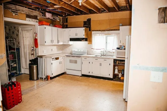 a living room with furniture a rug and a floor to ceiling window