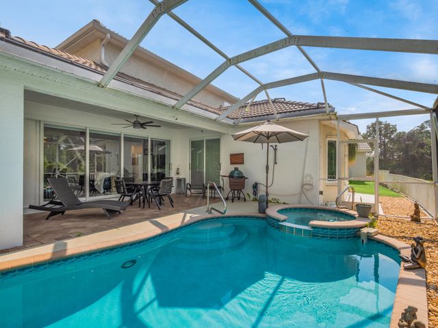 a view of a backyard with sitting area and furniture