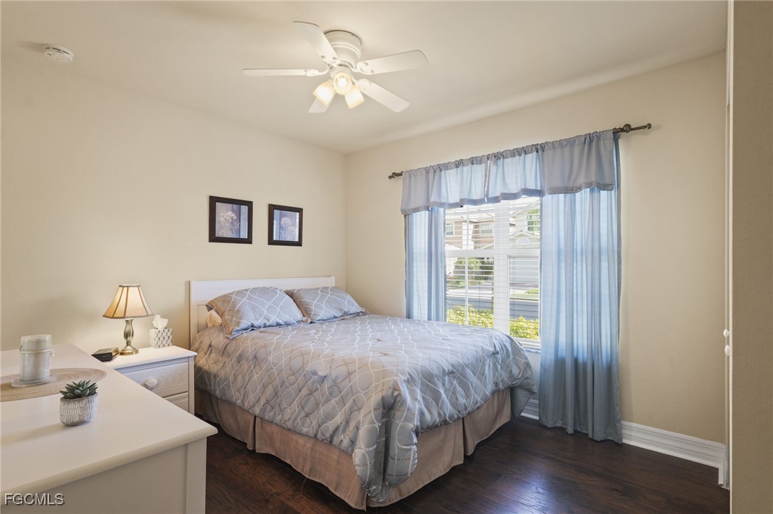 11040 Yellow Poplar Drive Fort Myers, FL 33913 - Photo 16 of 35 a bedroom with a bed and a chandelier