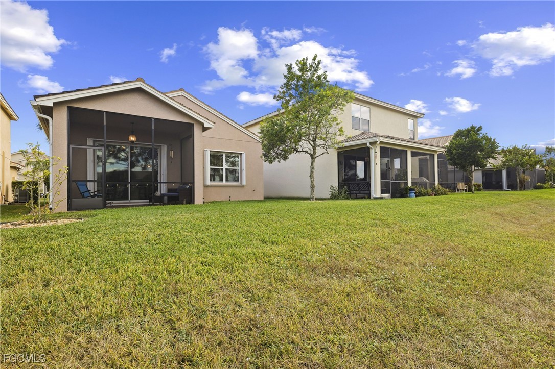 11040 Yellow Poplar Drive Fort Myers, FL 33913 - Photo 18 of 35 front view of a house with a yard