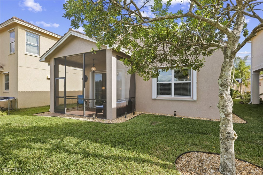 11040 Yellow Poplar Drive Fort Myers, FL 33913 - Photo 19 of 35 a view of a backyard with potted plants and large tree