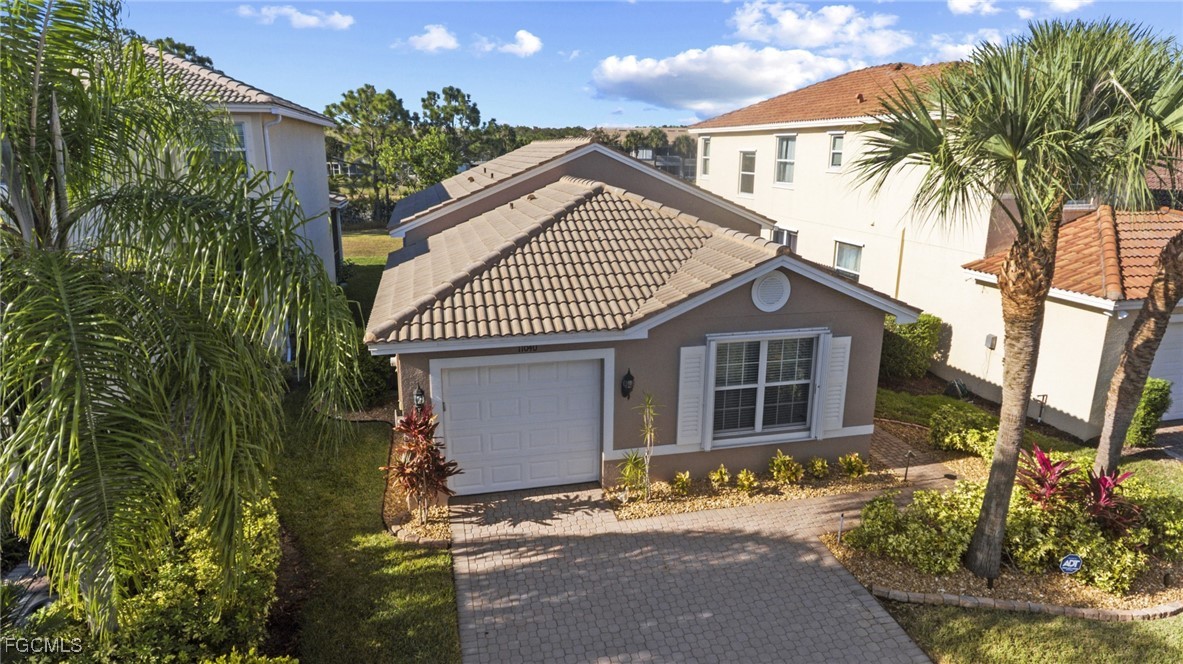 11040 Yellow Poplar Drive Fort Myers, FL 33913 - Photo 20 of 35 a view of a house with a yard and potted plants