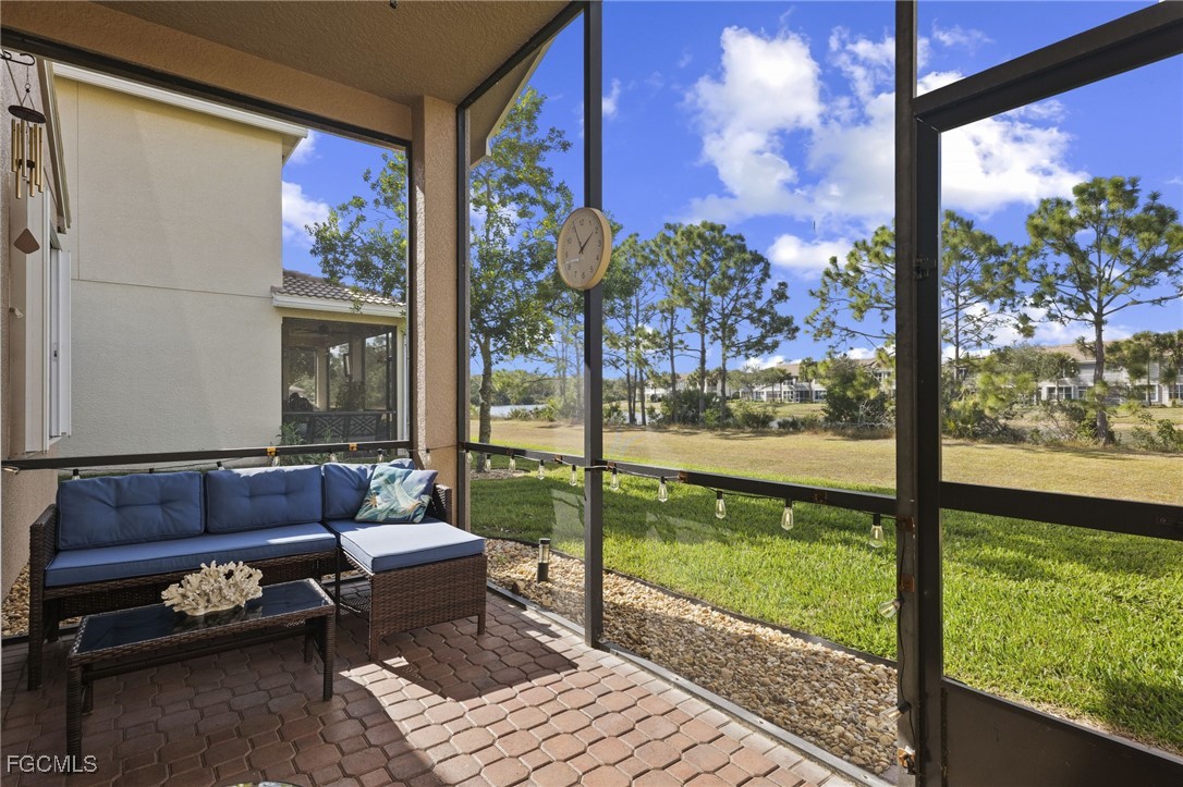 11040 Yellow Poplar Drive Fort Myers, FL 33913 - Photo 2 of 35 a living room with large windows and a table