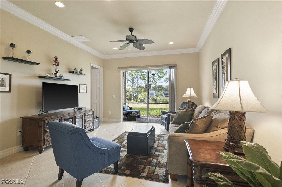 11040 Yellow Poplar Drive Fort Myers, FL 33913 - Photo 4 of 35 a living room with furniture a flat screen tv and a large window