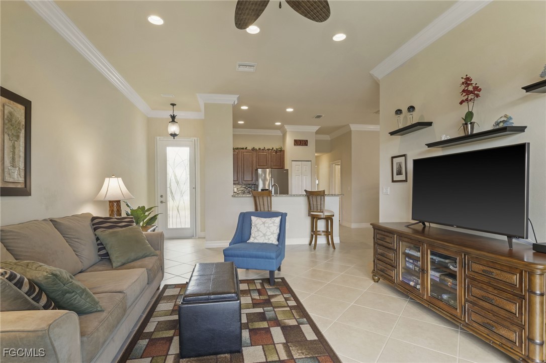 11040 Yellow Poplar Drive Fort Myers, FL 33913 - Photo 5 of 35 a living room with furniture and a flat screen tv
