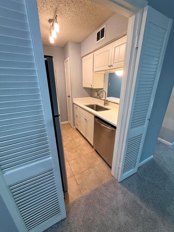 4845 Cedar Springs Road, Unit 174 Dallas, TX 75219 - Photo 5 of 19 a kitchen with white cabinets and white appliances