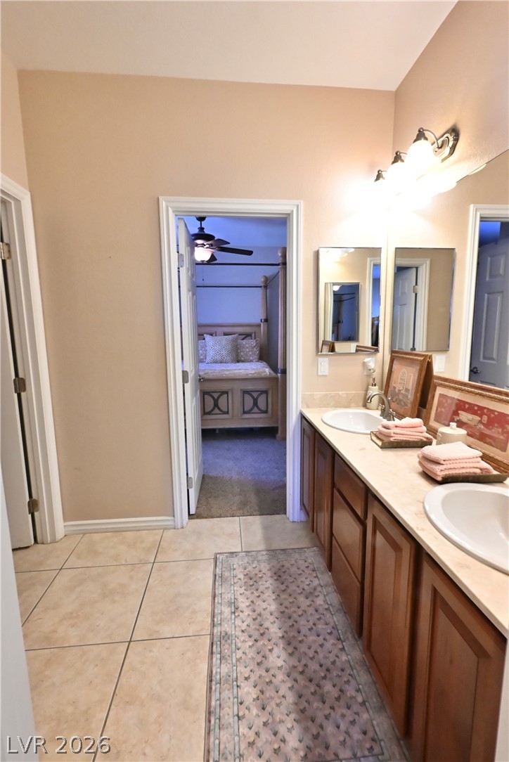2729 Kildrummie Street Henderson, NV 89044 - Photo 30 of 42 Double vanity sinks and bright lighting enhance this well-appointed primary bathroom.