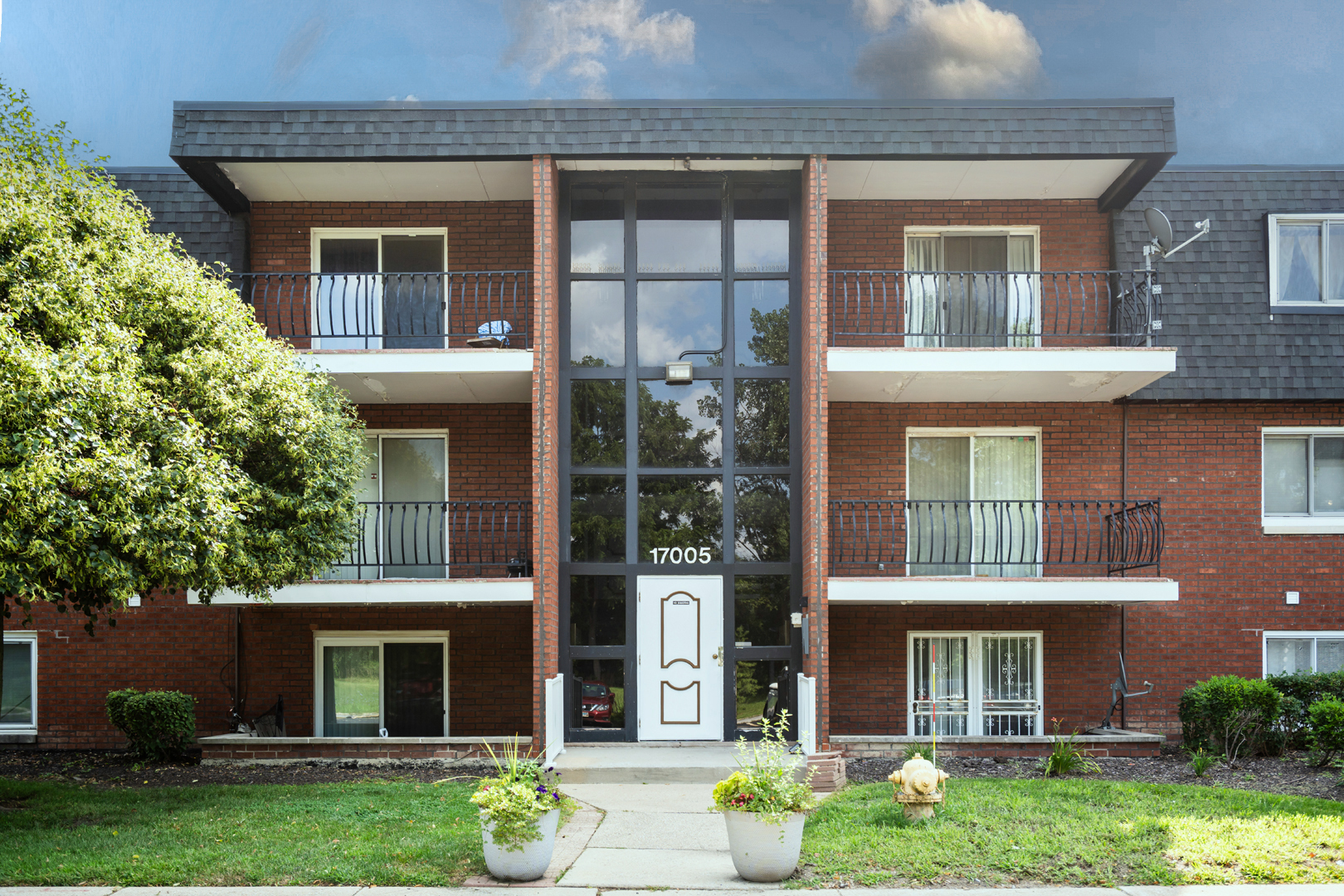 17005 Albany Avenue, Unit 202 Hazel Crest, IL 60429 - Photo 1 of 15 front view of a brick house with a yard and a large window