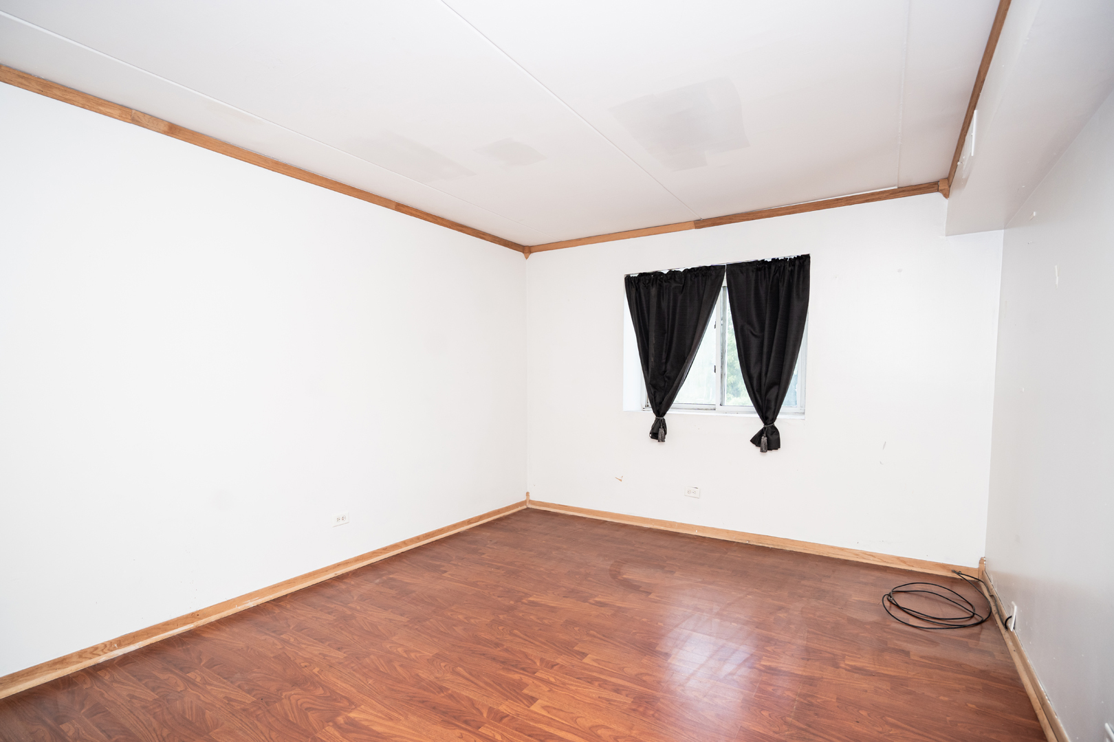 17005 Albany Avenue, Unit 202 Hazel Crest, IL 60429 - Photo 11 of 15 an empty room with wooden floor and windows