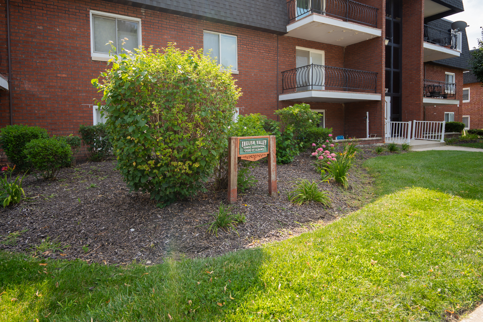 17005 Albany Avenue, Unit 202 Hazel Crest, IL 60429 - Photo 2 of 15 a view of a brick house with a yard and plants