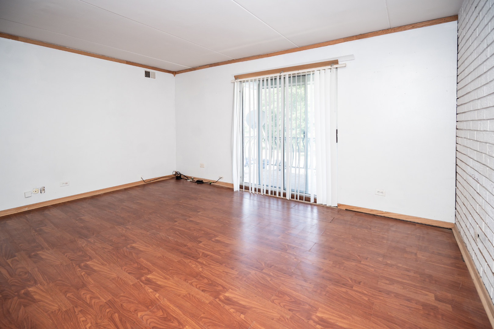 17005 Albany Avenue, Unit 202 Hazel Crest, IL 60429 - Photo 5 of 15 an empty room with wooden floor and windows